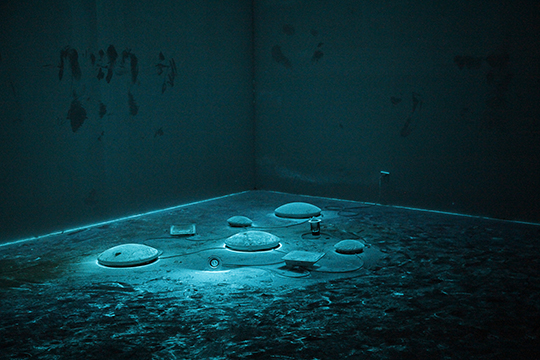 Once the lights are turned off, the florescent powder, covering Li Liao's piece emit an eerie light, 2015